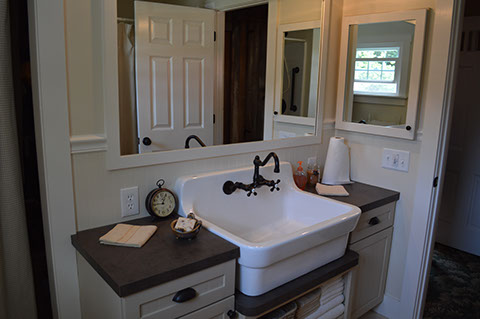 A large white farmhouse sink is located in the first floor bathroom.
